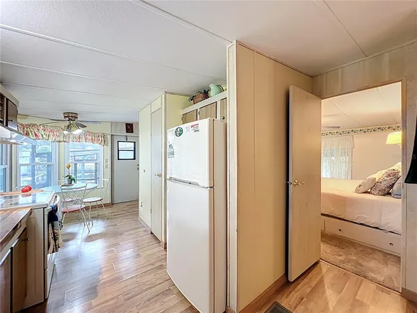 a dining room with furniture a chandelier and wooden floor