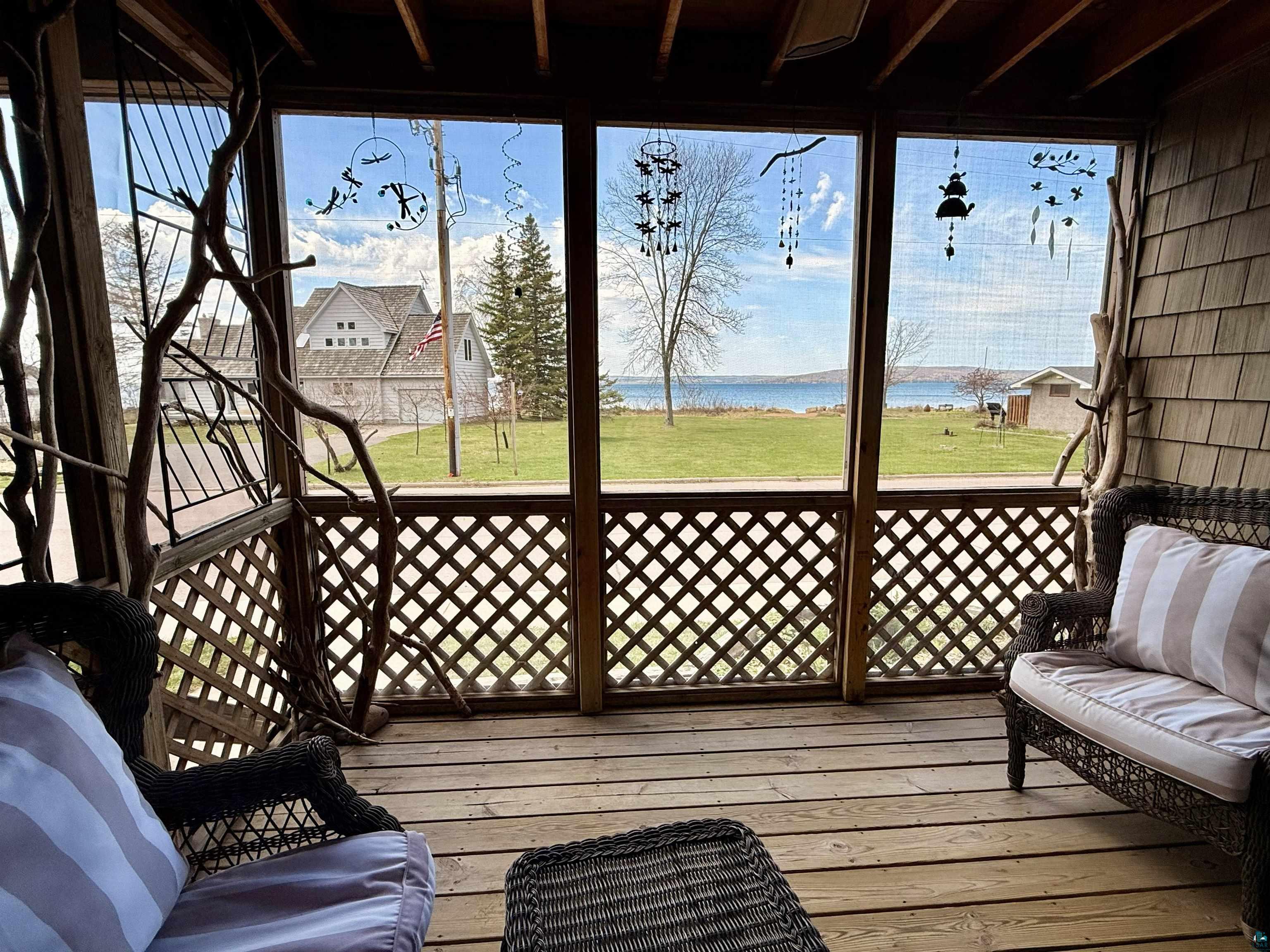 668 Fort Road, Unit 5 La Pointe, WI 54850 - Photo 3 of 27 First Level Screen Porch for entertaining, excellent book reading, and even some office work