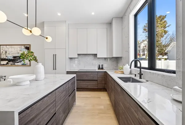 a kitchen with a sink stove and cabinets