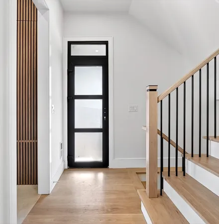 an empty room with wooden floor and a window