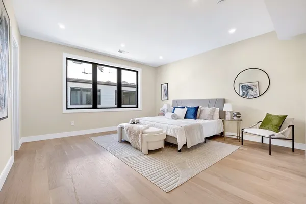 a spacious bedroom with a bed and window