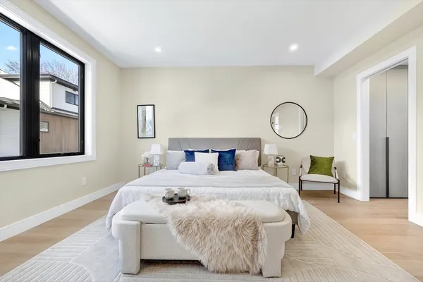 a bedroom with a bed and painting on the wall