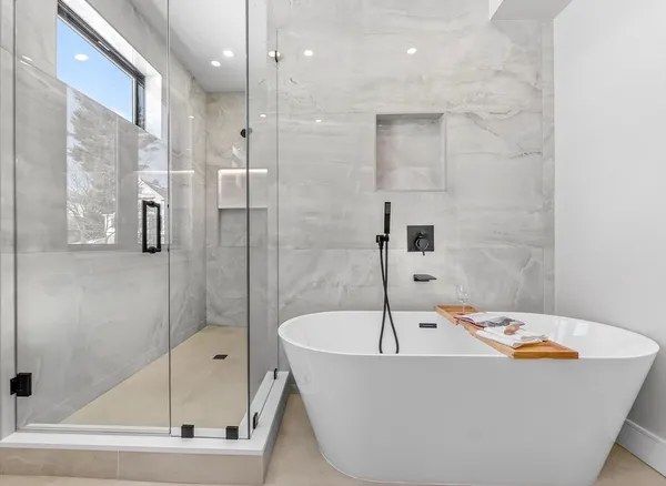 a bathroom with a tub and shower