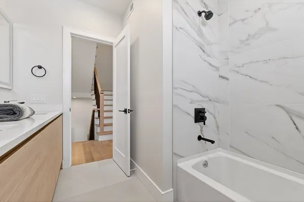 a bathroom with a bathtub and a sink