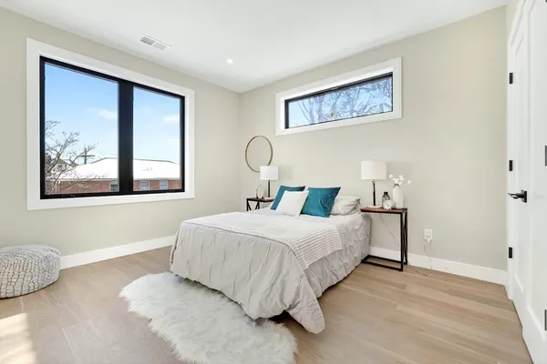 a bedroom with a bed and a painting on the wall