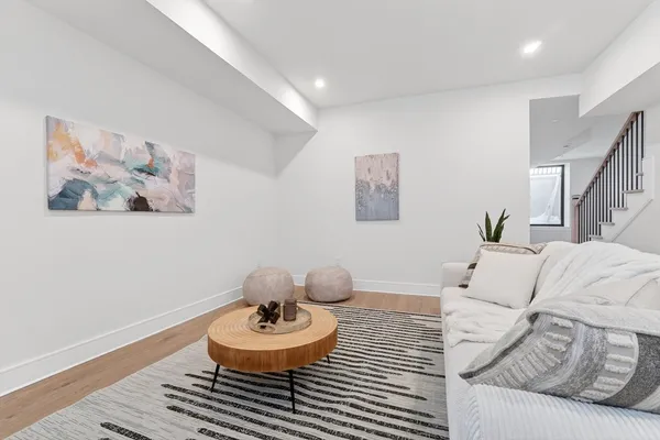 a living room with furniture and a wooden floor