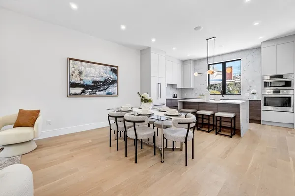a view of a dining room with furniture and wooden floor