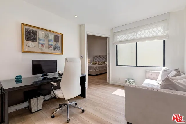 a living room with a couch a fireplace a flat screen tv and a floor to ceiling window