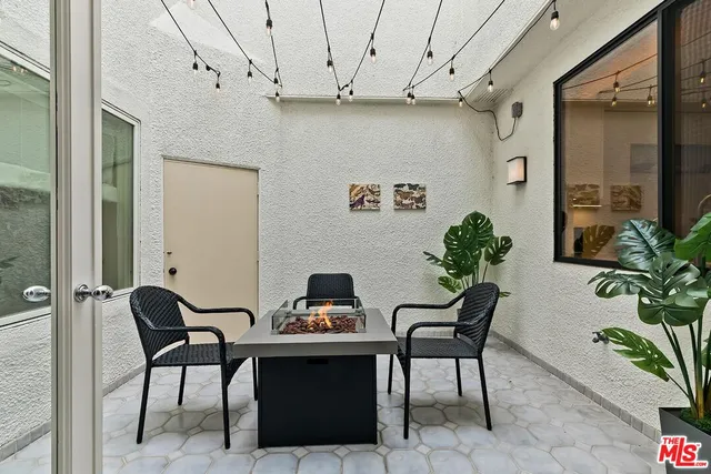 a large kitchen with a large window and stainless steel appliances