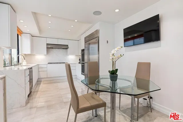 a bathroom with a granite countertop sink a mirror and vanity