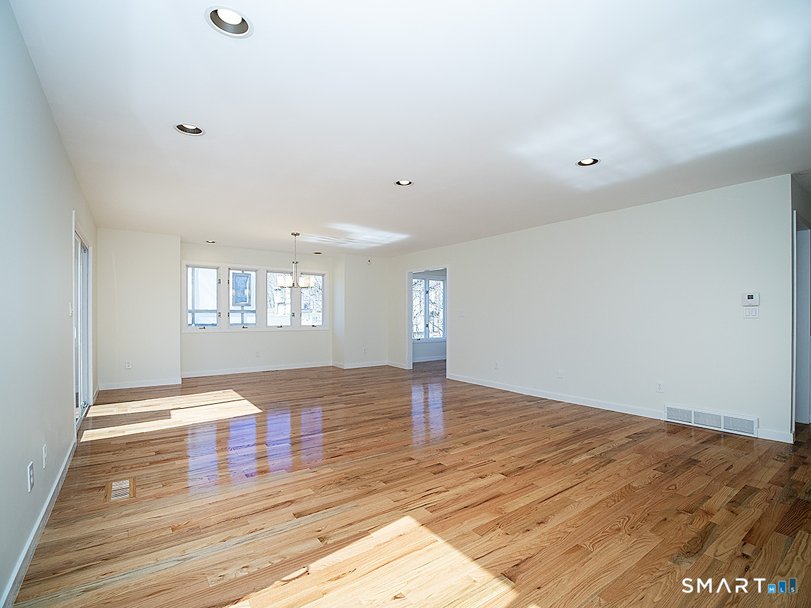 690 Forest Road, Unit 703 West Haven, CT 06516 - Photo 13 of 35 a view of an empty room with wooden floor and a window