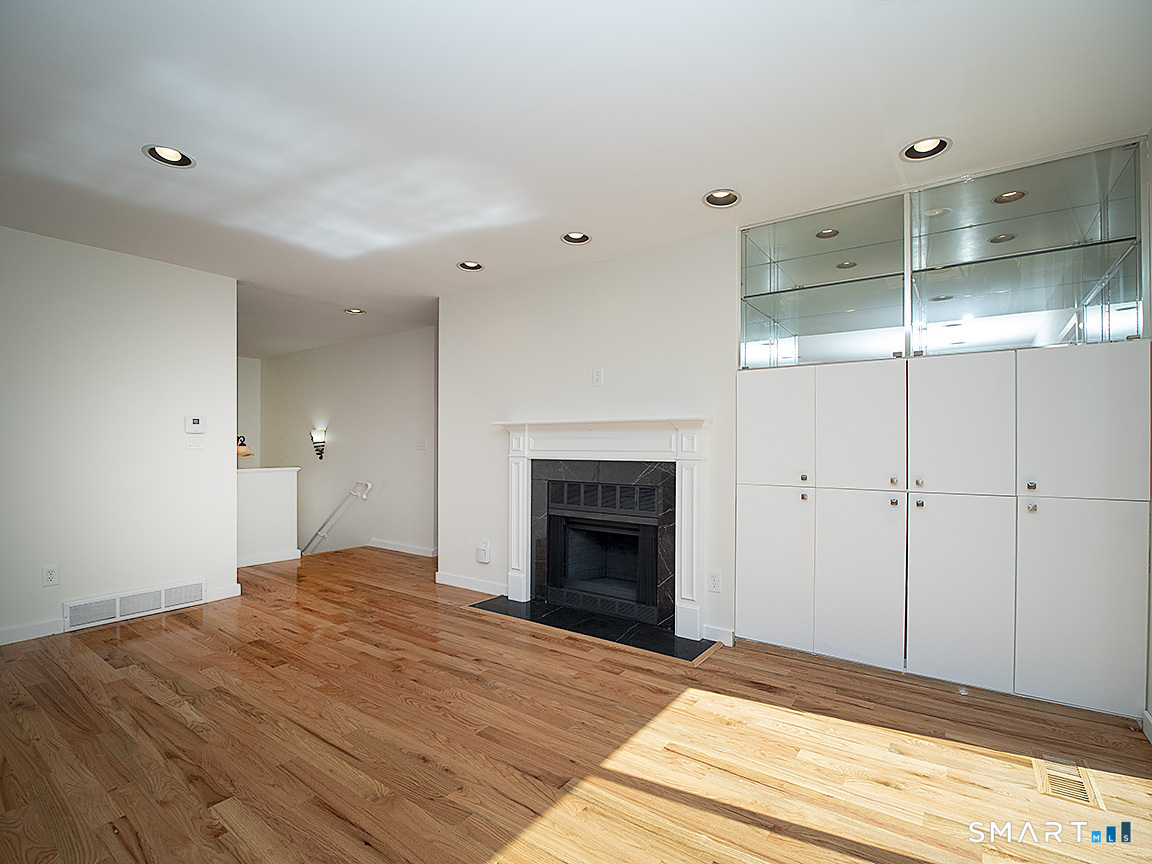 690 Forest Road, Unit 703 West Haven, CT 06516 - Photo 14 of 35 a bedroom with a bed and a fireplace