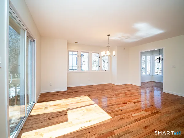 a view of a kitchen with wooden floor and windows