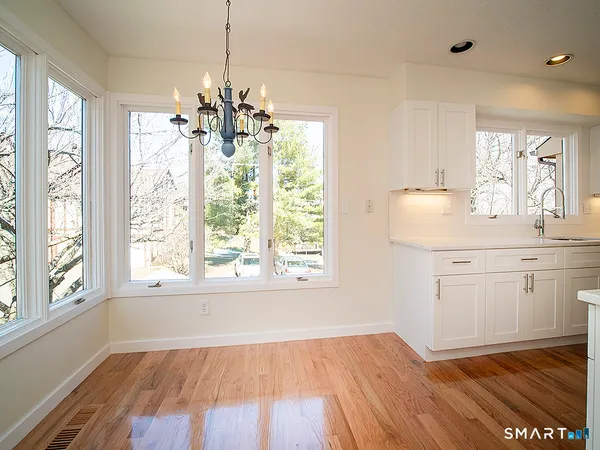 a view of kitchen with granite countertop cabinets and wooden floor