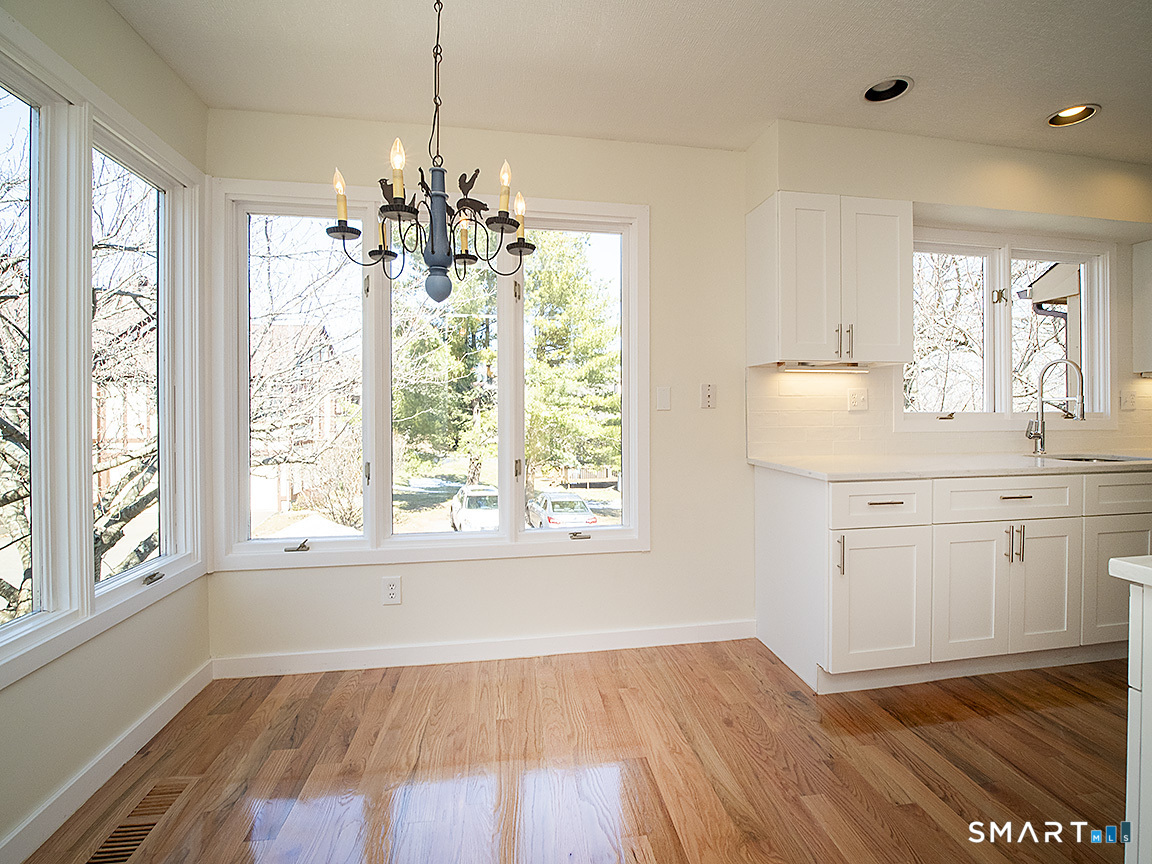 690 Forest Road, Unit 703 West Haven, CT 06516 - Photo 18 of 35 a view of a kitchen with wooden floor and windows