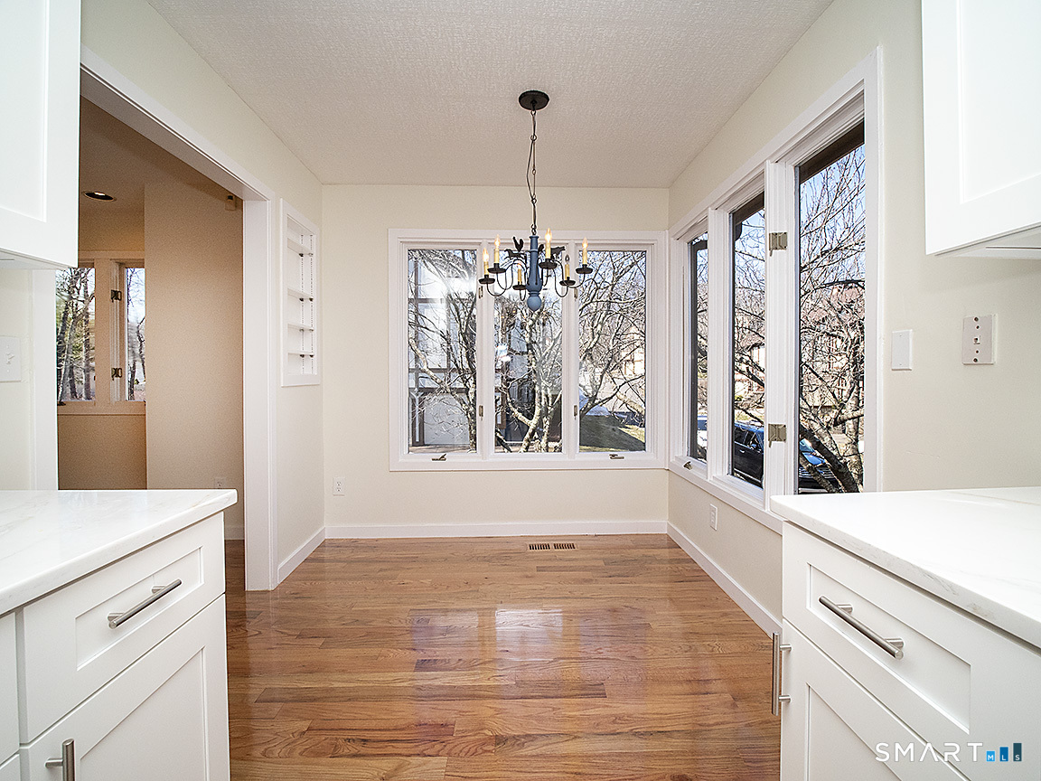 690 Forest Road, Unit 703 West Haven, CT 06516 - Photo 19 of 35 a view of kitchen with granite countertop cabinets and wooden floor