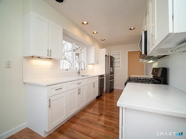 a kitchen with stainless steel appliances granite countertop a sink and cabinets