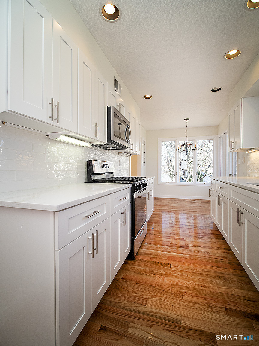 690 Forest Road, Unit 703 West Haven, CT 06516 - Photo 22 of 35 a kitchen with stainless steel appliances granite countertop a sink and cabinets
