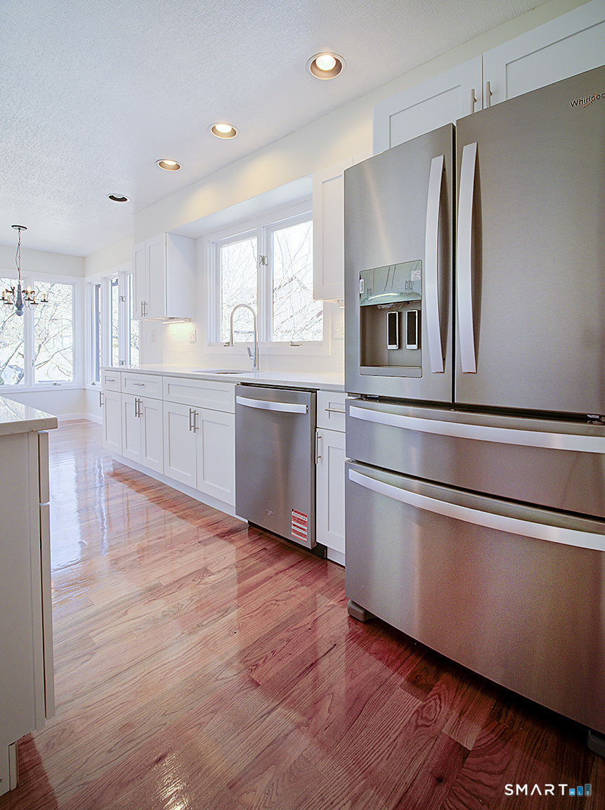 690 Forest Road, Unit 703 West Haven, CT 06516 - Photo 23 of 35 a kitchen with stainless steel appliances granite countertop a refrigerator and a stove top oven