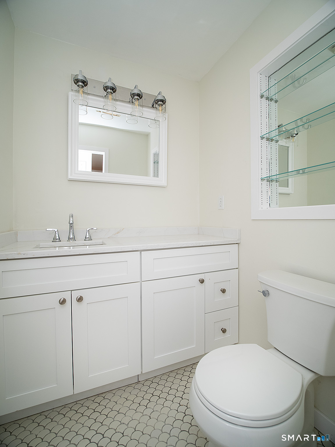 690 Forest Road, Unit 703 West Haven, CT 06516 - Photo 26 of 35 a bathroom with a sink a toilet and mirror