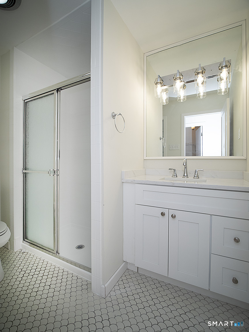 690 Forest Road, Unit 703 West Haven, CT 06516 - Photo 27 of 35 a bathroom with a sink a toilet and shower