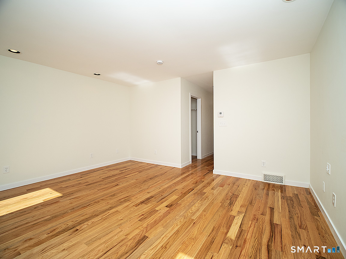 690 Forest Road, Unit 703 West Haven, CT 06516 - Photo 31 of 35 a view of empty room with wooden floor