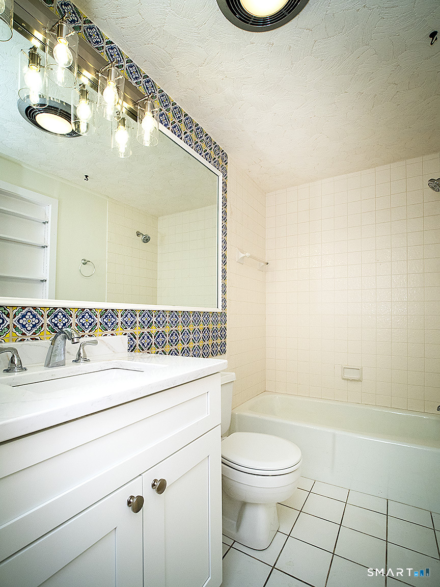 690 Forest Road, Unit 703 West Haven, CT 06516 - Photo 33 of 35 a bathroom with a sink a toilet and shower