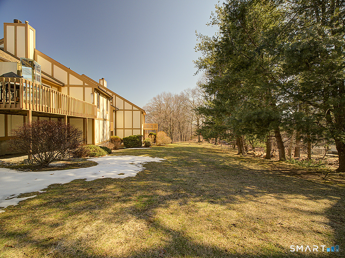 690 Forest Road, Unit 703 West Haven, CT 06516 - Photo 6 of 35 a view of a house with a yard and tree s