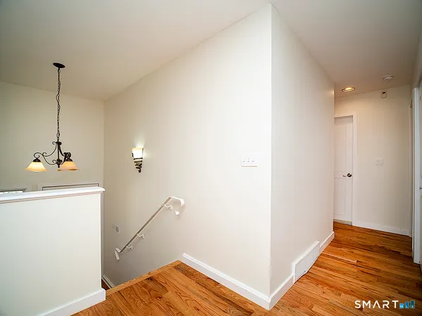 a view of a room with wooden floor and bedroom