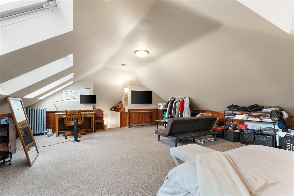35 Richardson Street, Unit 2 Wakefield, MA 01880 - Photo 23 of 32 a living room with furniture gym equipment and a flat screen tv
