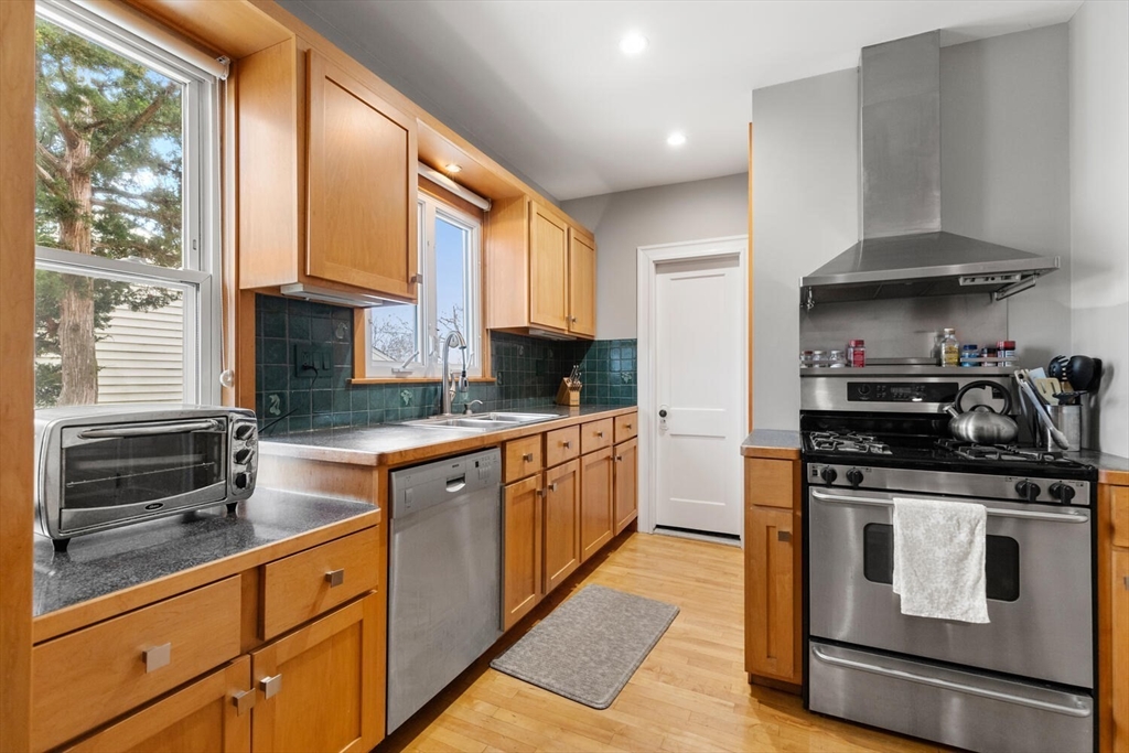 35 Richardson Street, Unit 2 Wakefield, MA 01880 - Photo 6 of 32 a kitchen with stainless steel appliances granite countertop a stove a sink and a granite counter tops