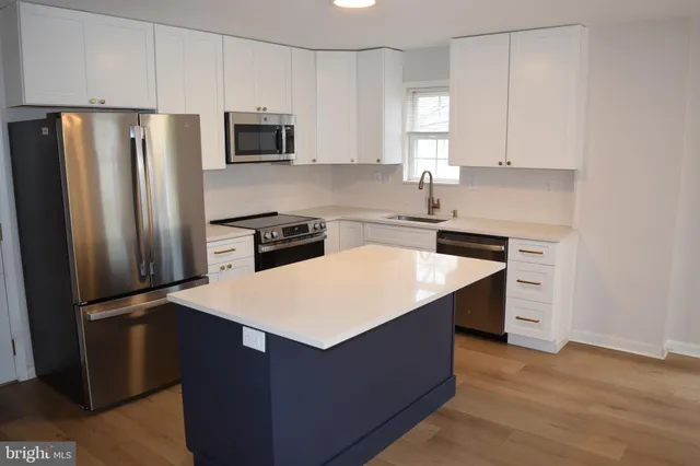 a kitchen with a refrigerator sink and microwave