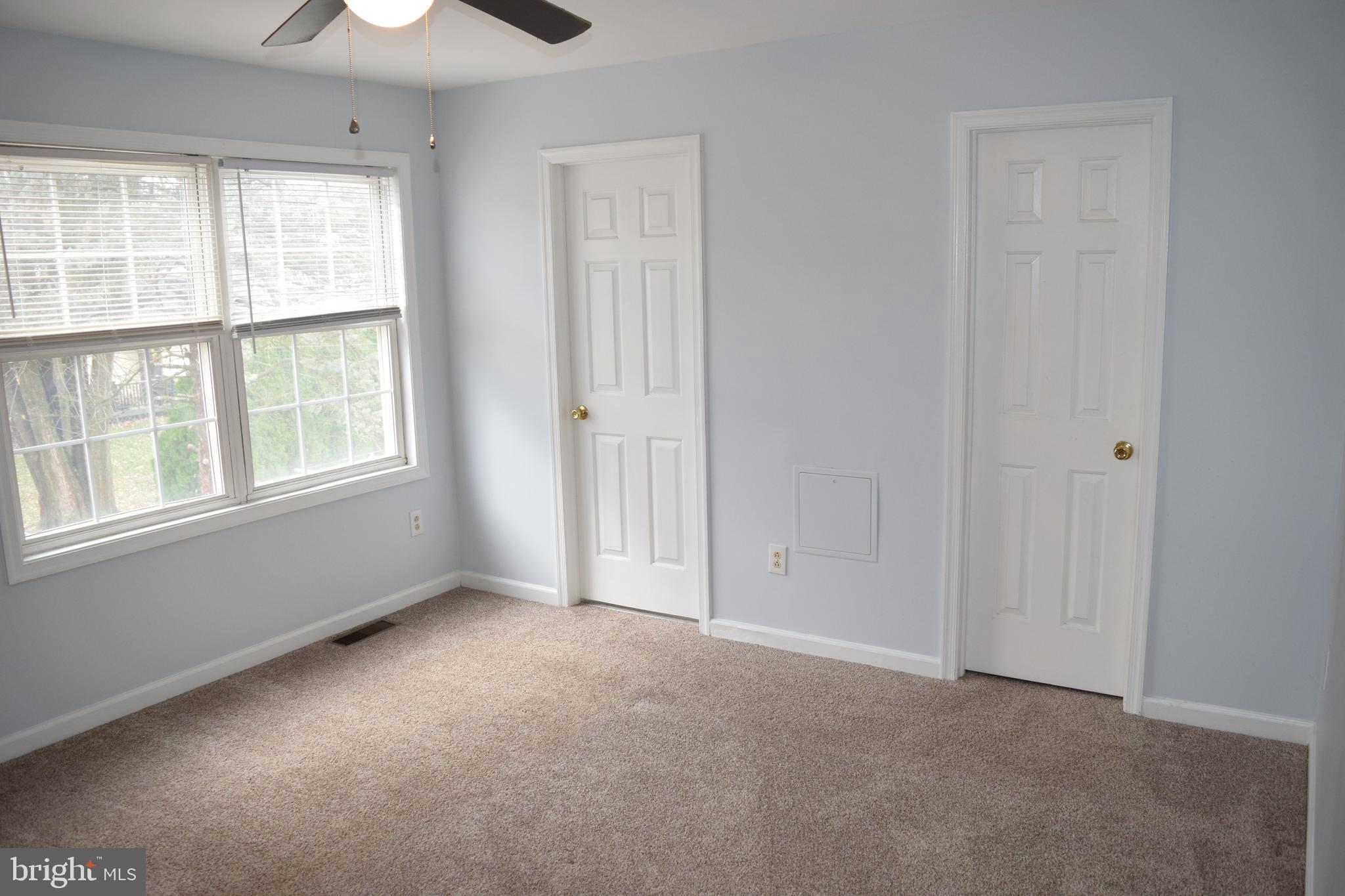 3011 Roberts Road Aston, PA 19014 - Photo 9 of 17 an empty room with windows and chandelier fan