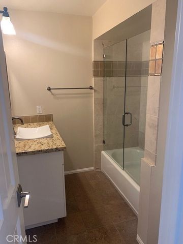a bathroom with a granite countertop sink a toilet and bathtub