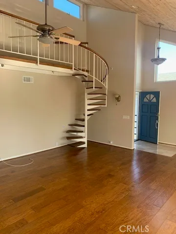 a view of a room with wooden floor