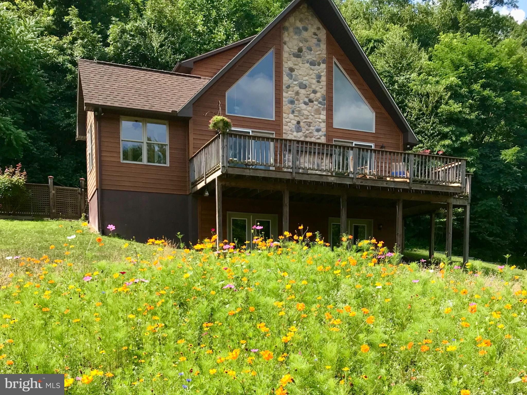 Charming home amidst vibrant blooms.