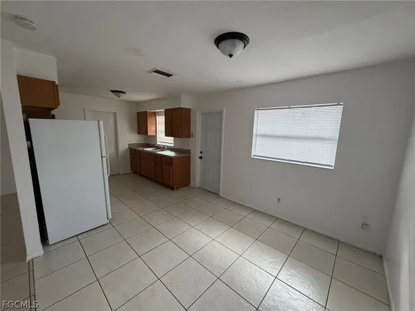 a kitchen with refrigerator and window