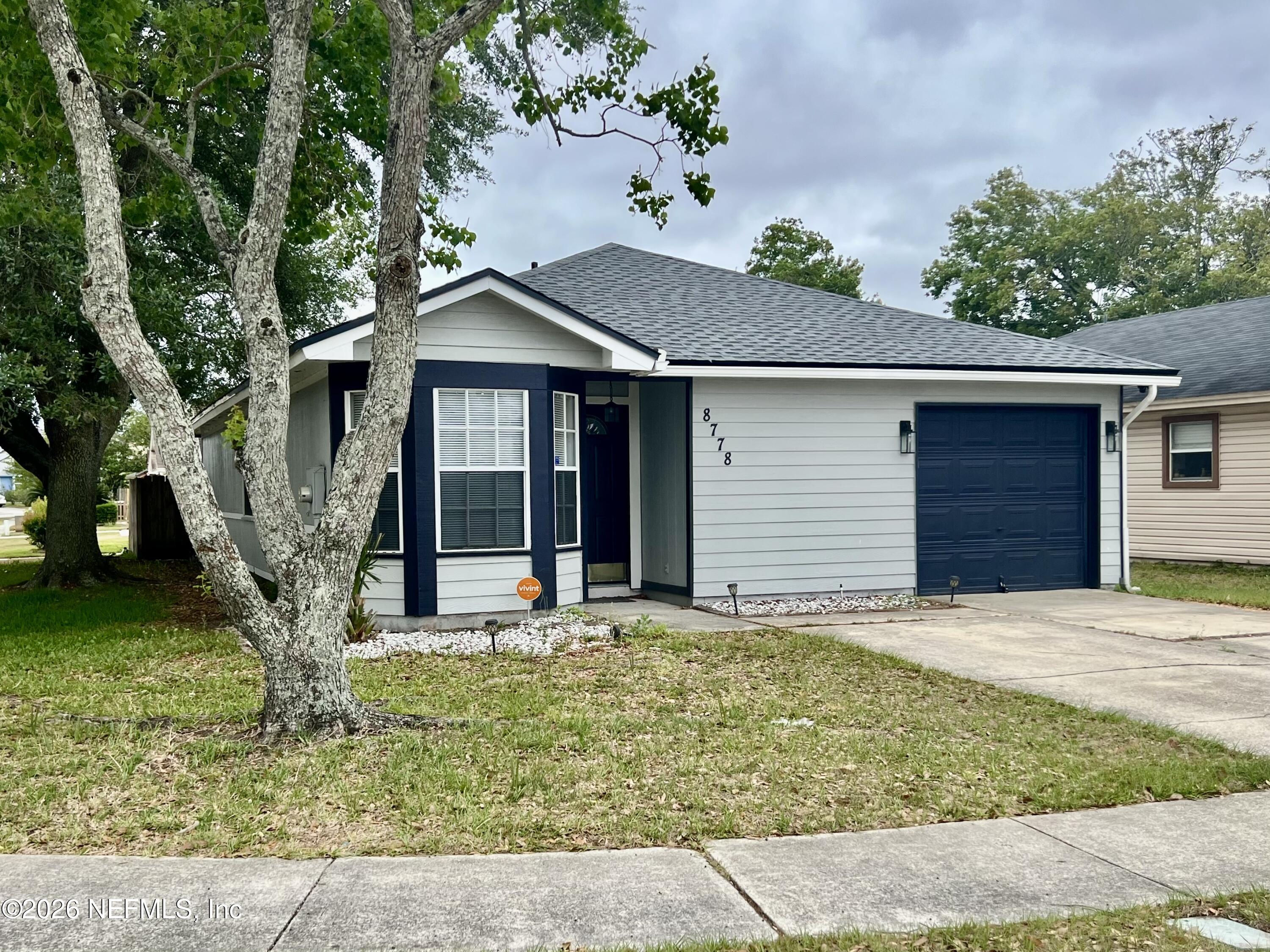 8778 Buzz Court Jacksonville, FL 32216 - Photo 1 of 22 a front view of a house with garden