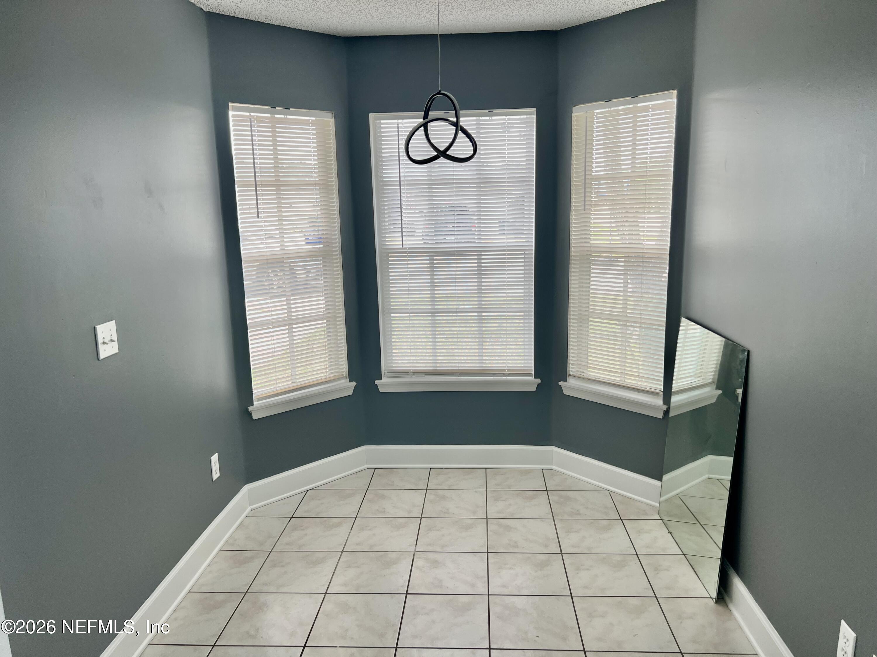 8778 Buzz Court Jacksonville, FL 32216 - Photo 11 of 22 a view of an empty room and window