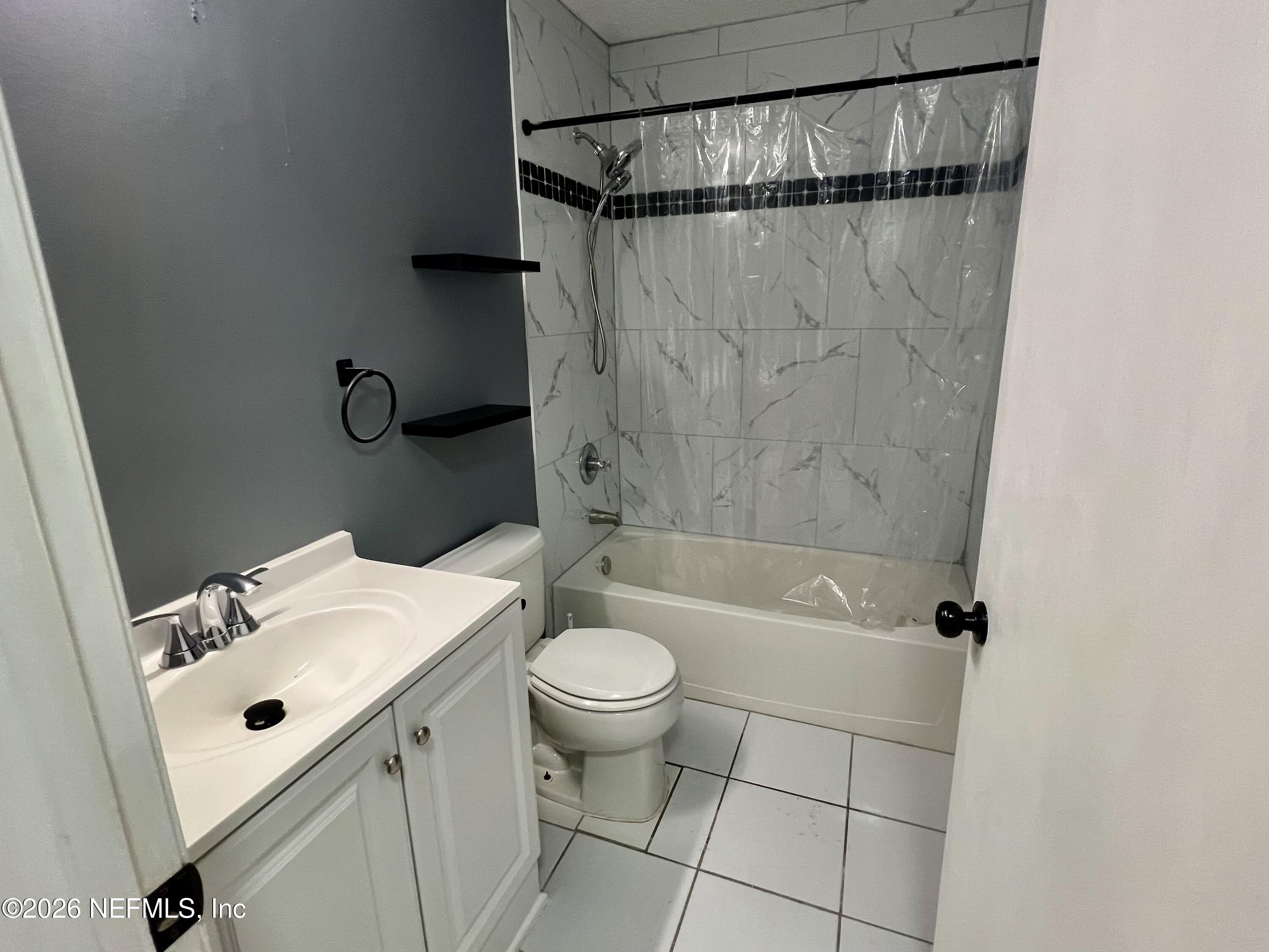 8778 Buzz Court Jacksonville, FL 32216 - Photo 14 of 22 a bathroom with a sink a toilet and shower