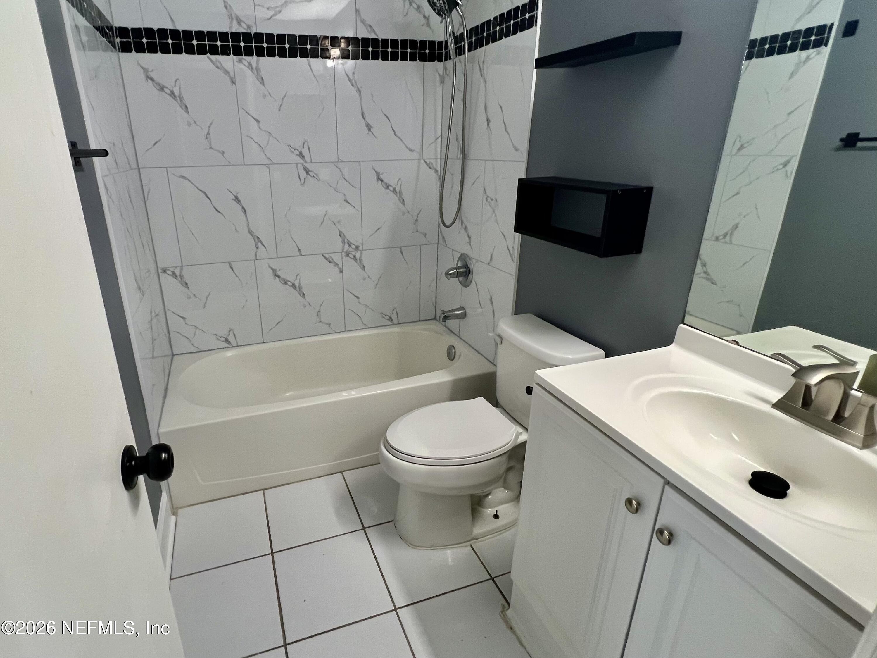 8778 Buzz Court Jacksonville, FL 32216 - Photo 16 of 22 a bathroom with a sink toilet and shower