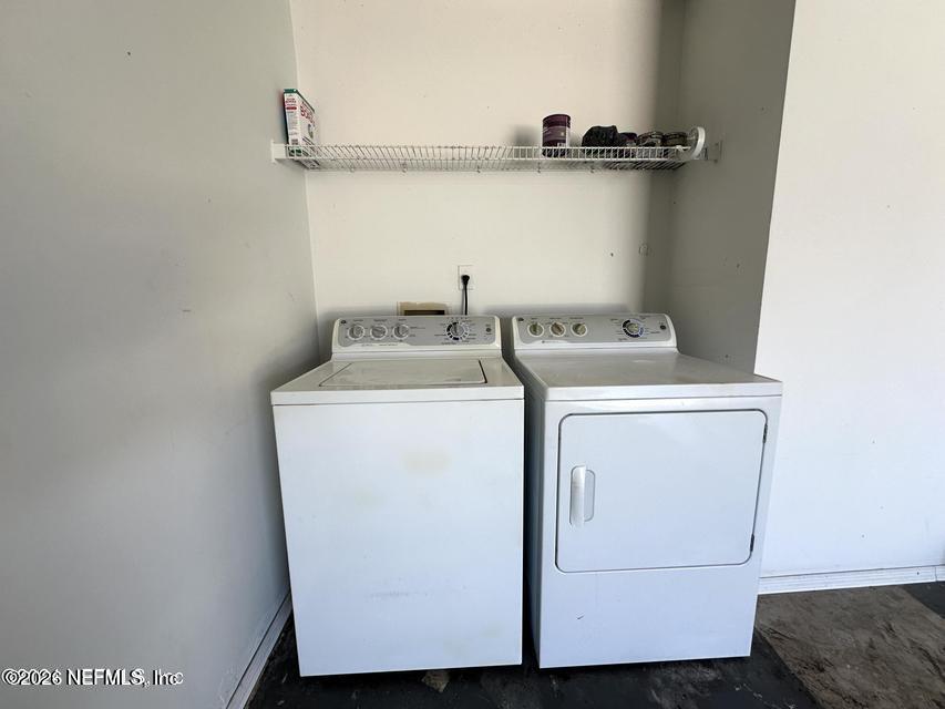 8778 Buzz Court Jacksonville, FL 32216 - Photo 17 of 22 a utility room with dryer and washer