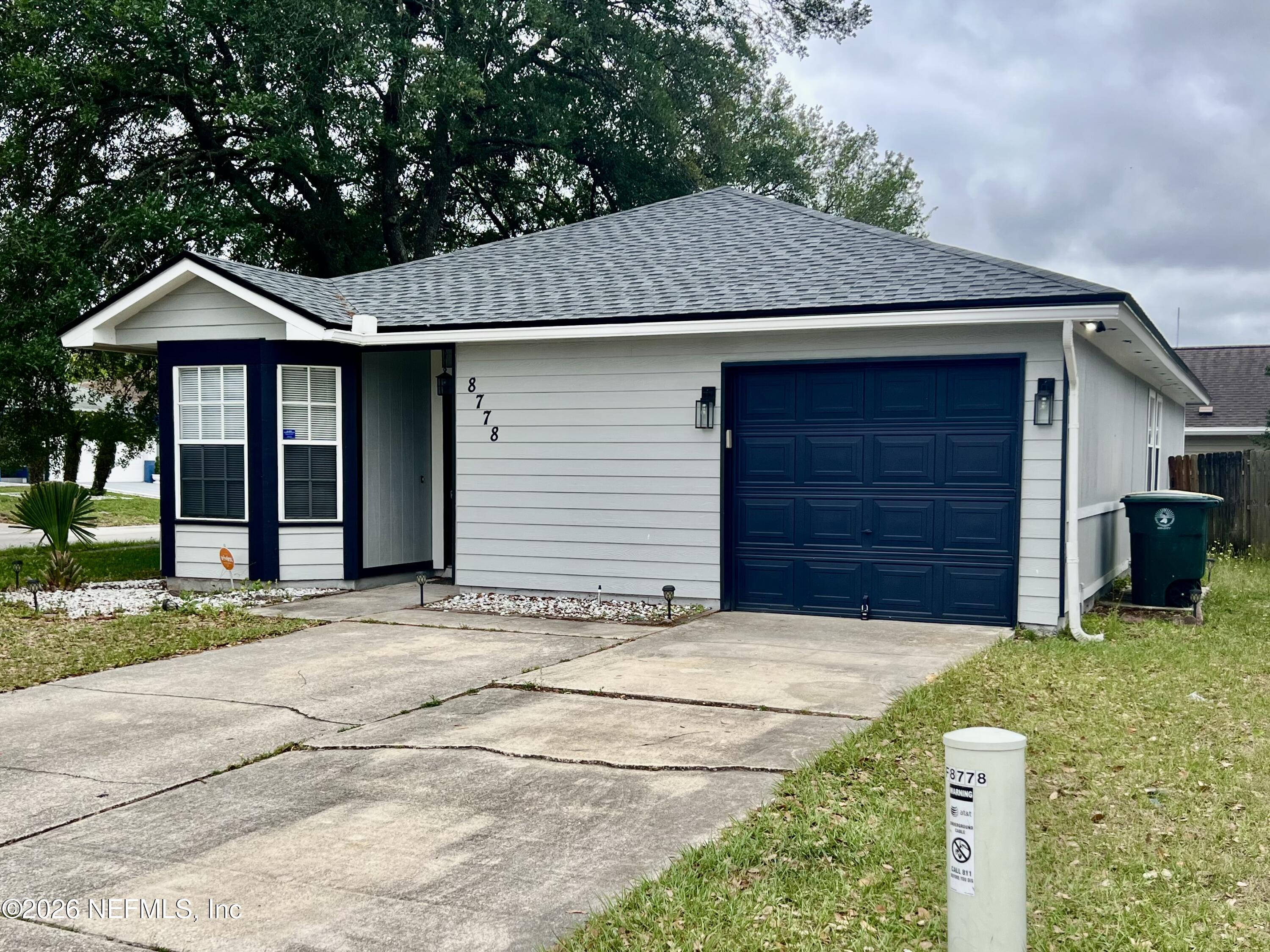 8778 Buzz Court Jacksonville, FL 32216 - Photo 2 of 22 a front view of a house with a yard