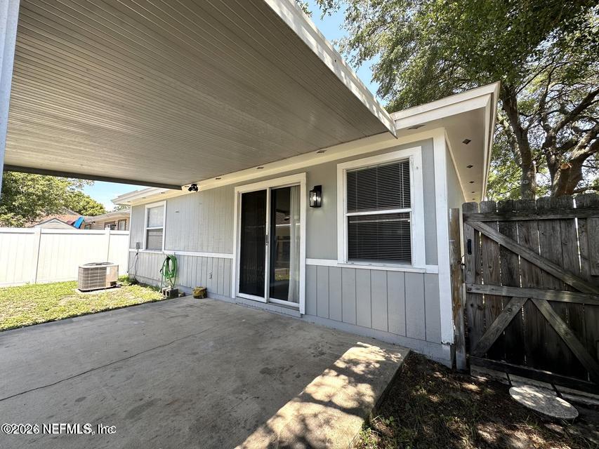 8778 Buzz Court Jacksonville, FL 32216 - Photo 21 of 22 a view of backyard with large trees and wooden fence