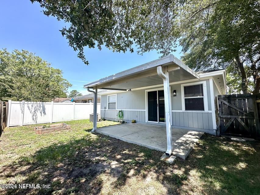 8778 Buzz Court Jacksonville, FL 32216 - Photo 22 of 22 a front view of a house with garden