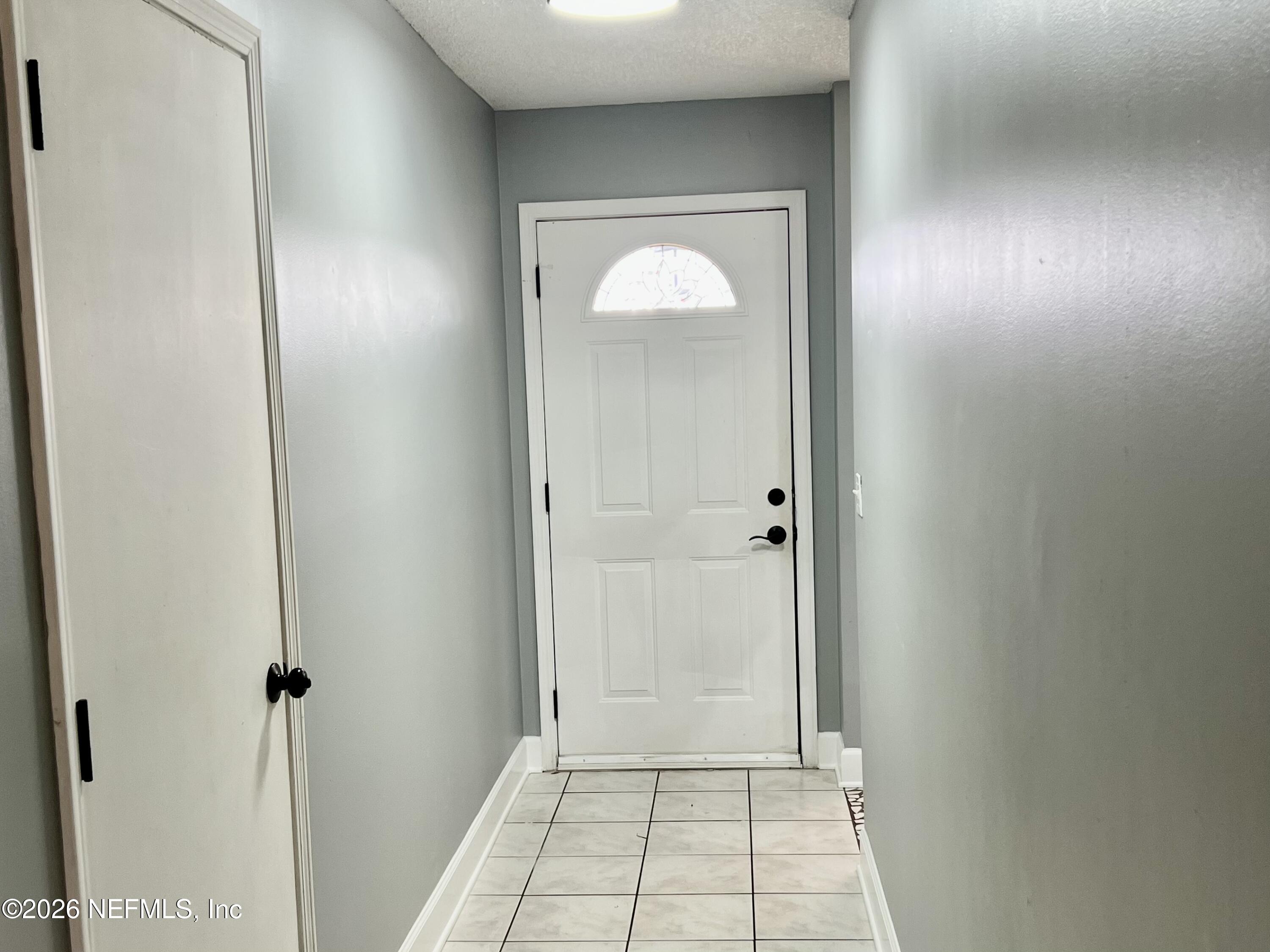 8778 Buzz Court Jacksonville, FL 32216 - Photo 4 of 22 a view of a hallway with wooden floor
