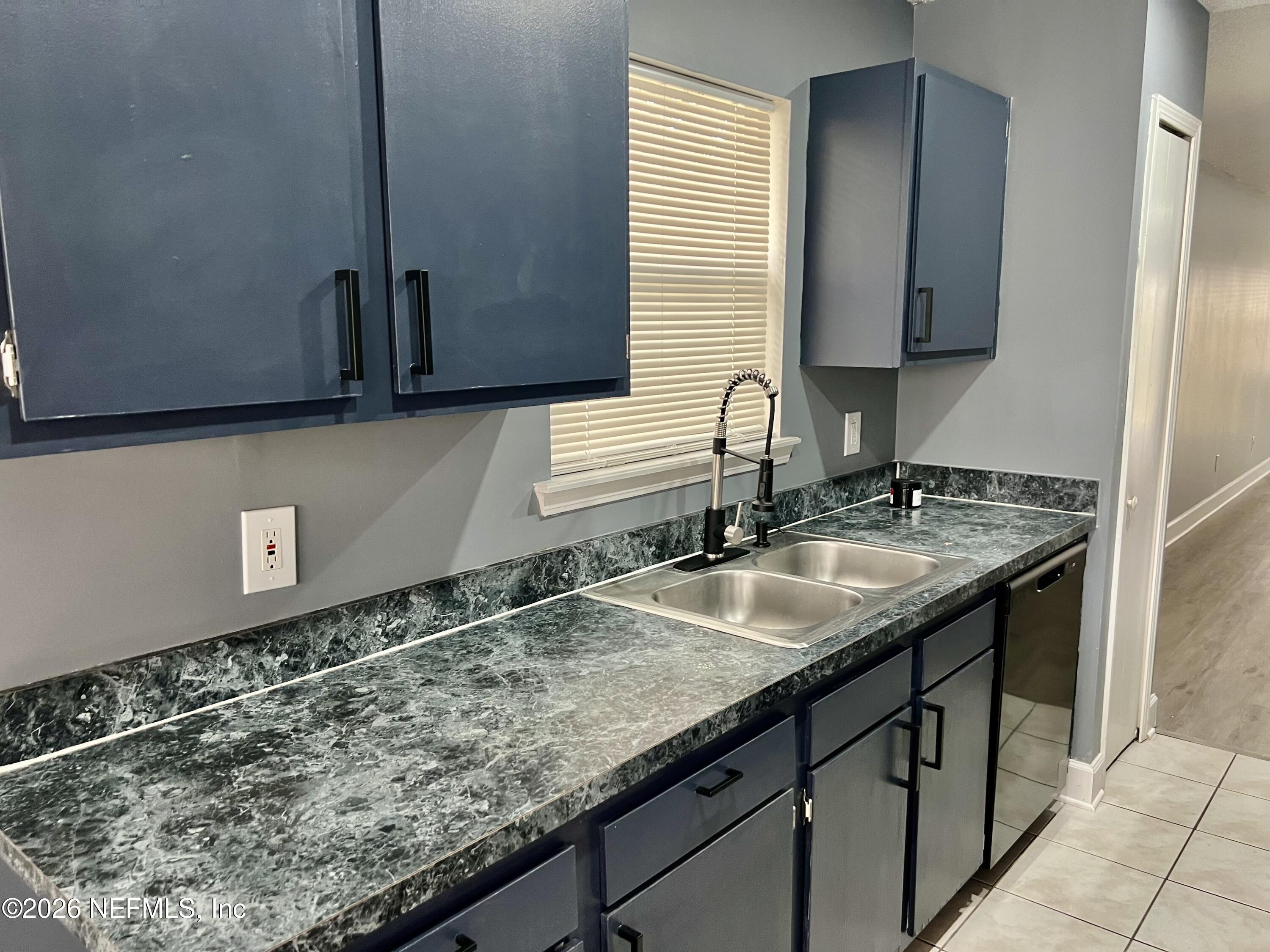 8778 Buzz Court Jacksonville, FL 32216 - Photo 7 of 22 a bathroom with a granite countertop sink and a mirror
