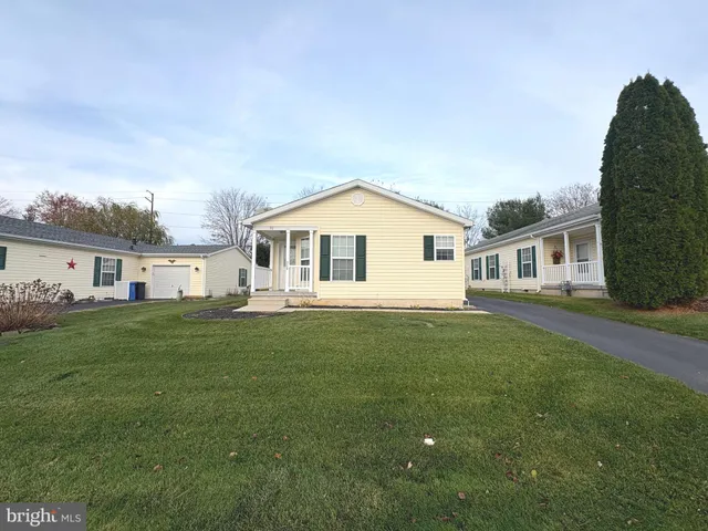 a view of house with a big yard