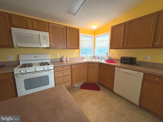 a kitchen with sink and cabinets