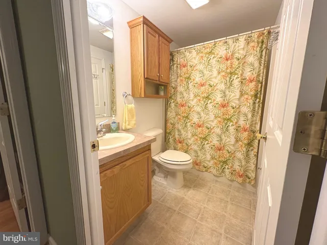 a bedroom with a bed couch and a window